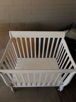 white wooden baby crib