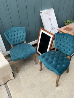 2 green suede chairs