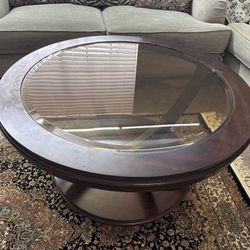 Round wooden coffee table with glass top
