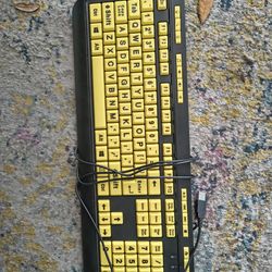 This is a high-contrast computer keyboard designed for visually impaired users, featuring large yellow keycaps with bold black lettering for improved 