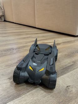 Large black Batman Batmobile toy in good used condition. Great if you have a Batman figurine that fits right in there . Cool armored design with openi