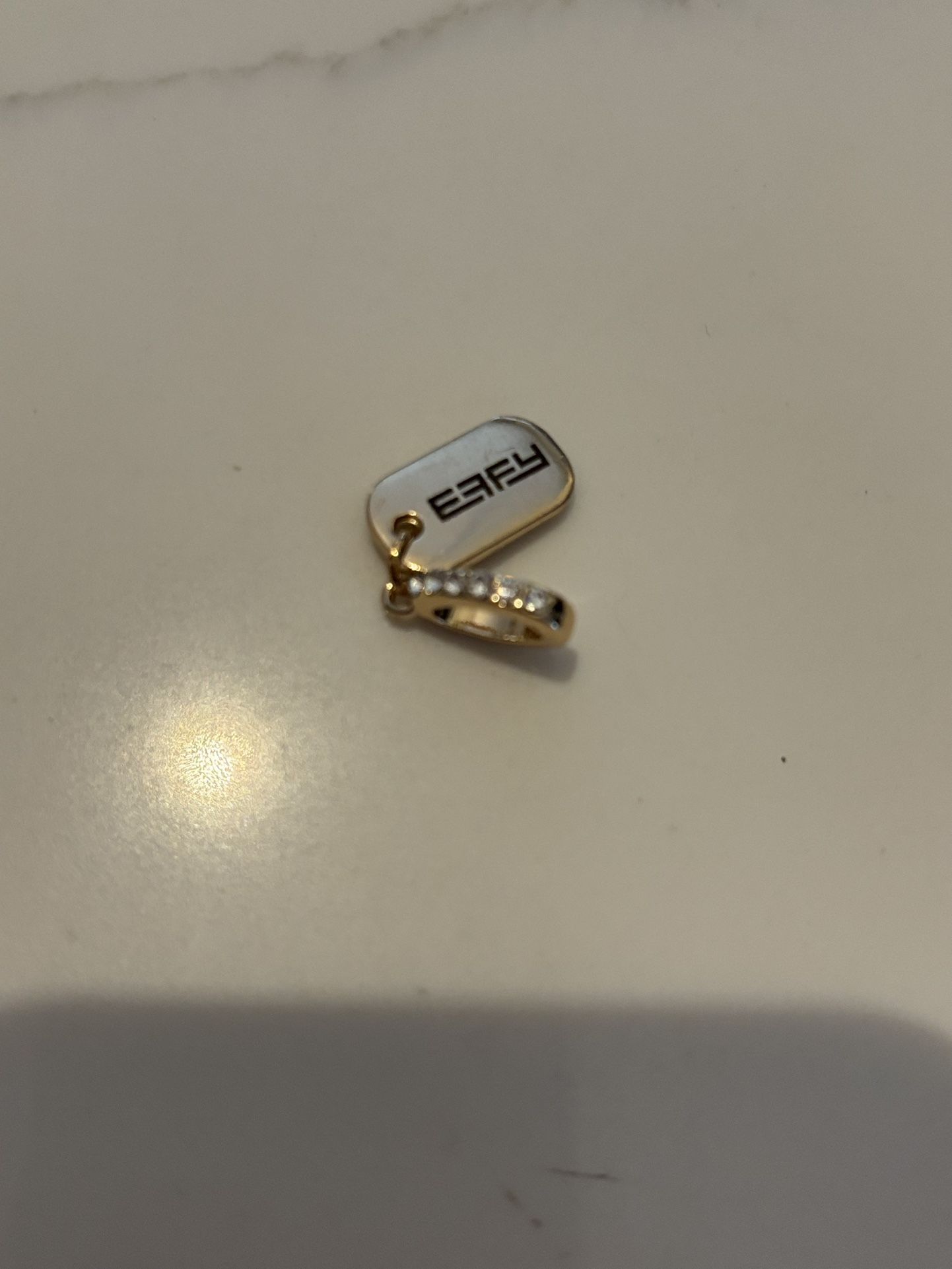 Effy brand charm gold tone tag pendant.