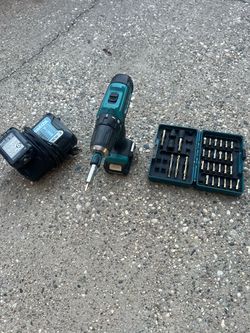 Makita drill, spare battery, charger, and bit set