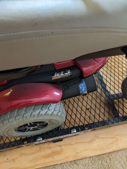 Powered wheel chair with hydraulic lift hitch carrier