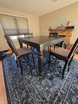 East West Furniture Chelsea set features a square black counter-height table with a self-storing butterfly leaf.