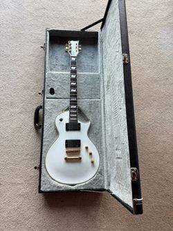 ESP LTD Deluxe EC 1000 T electric guitar with a case.