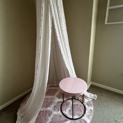 Pink canopy with rug and table