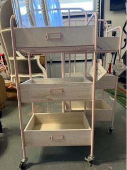 2 powder pink rolling storage carts, art carts
