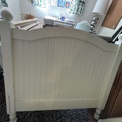 Twin bed frame with mattress and box spring.