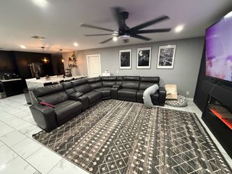 Power reclining sectional , 2 consoles with cup holders.