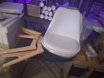 Modern white upholstered chair with a curved wraparound back and padded seat, sleek minimalist design, works well for dining, desk, vanity, or accent