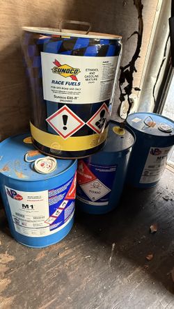 Empty Sunoco And VP Racing Race Fuel containers great for display