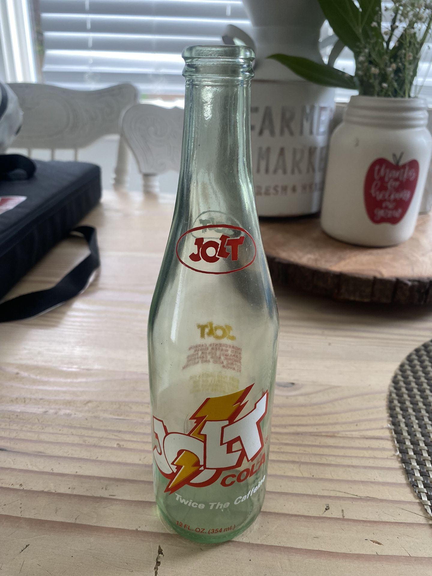 vintage glass bottle of Jolt Cola, a highly caffeinated soft drink originally launched in 1985. Here's some information about it: Jolt Cola was known