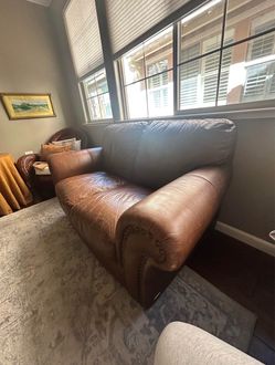 Beautiful brown leather loveseat.