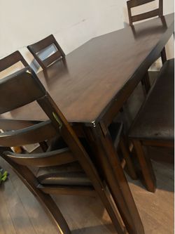 Fairly used wooden table with chairs and bench included