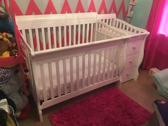 White crib with changing table