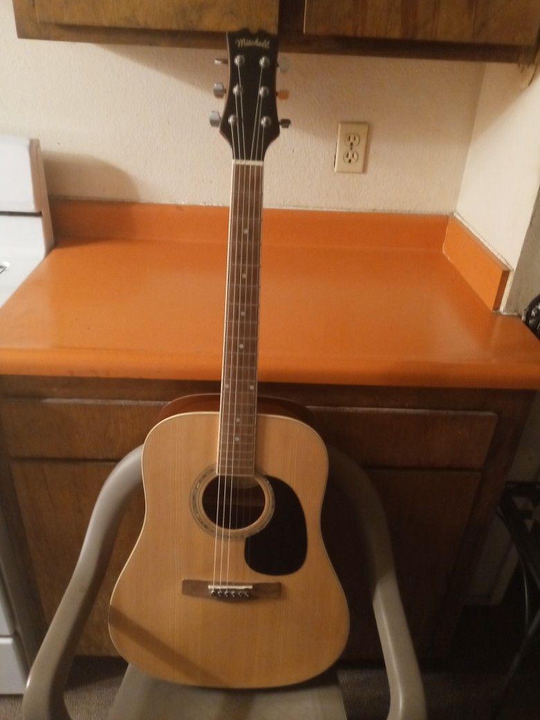 MITCHELL ACOUSTIC GUITAR. BRAND NEW STRINGS. SOUNDS GOOD. NICE SHINE ON GUITAR. 