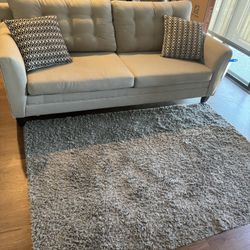 Super light weight Nautical super comfortable 3 seater couch paired with a 5by 7ft gray rug.