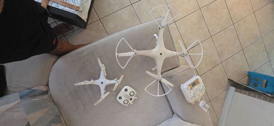 Two White RC Quadcopter Drones with Controllers