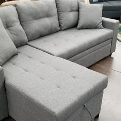 Small reversible sofa chaise sectional with a pullout bed