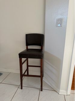 **Title:** Bar Stool Chair – Dark Brown Faux Leather & Wood – Good Condition  **Description:** Modern bar stool chair with dark brown faux leather sea