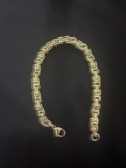 Elegant Silver toned bracelet with a Byzantine link design. This piece has a polished finish and a secure lobster claw clasp.