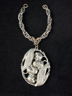 $68. Vintage antique Art Nouveau Lily of the Valley pewter bracelet made in Germany. Bracelet is 8 inches long. Pendant is 3 in long and 2 in wide.