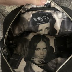 Vintage Victoria's Secret "Angel" black mini shoulder bag with a braided strap and pink lettering.