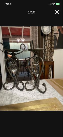 Set of two wrought iron candle holders holding glass strawberries