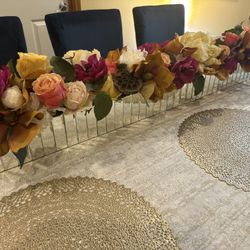 floral table runner featuring a variety of artificial flowers and foliage.