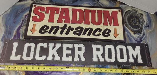 two decorative metal signs featuring a "STADIUM entrance" and "LOCKER ROOM" sign