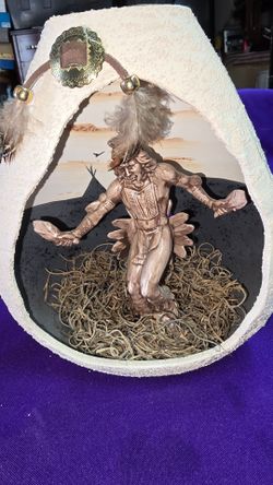 Southwest Decorative Collectible Native American Indian Sculpture housed inside a hollow, textured ceramic gourd, performing a rain dance with feather