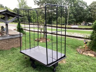 METAL RACK ON WHEELS IN VERY GOOD CONDITION ROLLS AS IT SHOULD (71”TALL  X  57”LONG  X  32”WIDE)