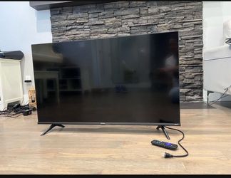 Westinghouse 4K Ultra HD Smart Roku TV, featuring a slim black bezel and angular side legs