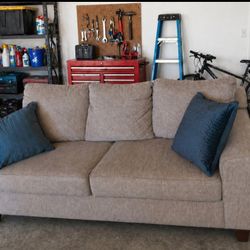 Gray Comfortable Sofa With 2 Blue Pillows