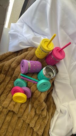 These are Elk and Friends stainless steel mason jar cups featuring brightly colored silicone sleeves and lids