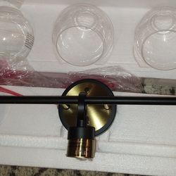 Elegant 25 in. 3 Light Black and Brushed Gold Vanity Light with Clear Glass Shades