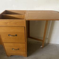 Filing cabinet with fold out desk