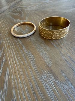 Coach brand bracelet and sparkling gold and diamond bracelet.