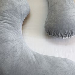 Momcozy brand body pillow for women or men. Comfortable machine washable cover