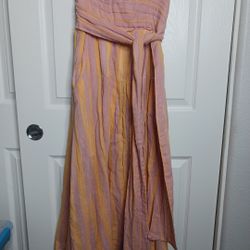 The Free People "Stripe Me Up" Yellow & Pink Strapless Midi Dress in size XS is a whimsical and lightweight dress designed for various occasions such 
