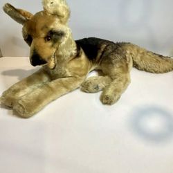 The is a vintage Steiff "Arco" German Shepherd dog from the 1950s, made of mohair.   It is a toy dog measuring 21 inches and features the sign