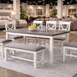 White dining table 4 chairs and a bench.
