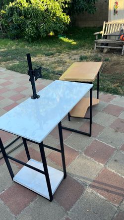 Two students desktop one with computer stand