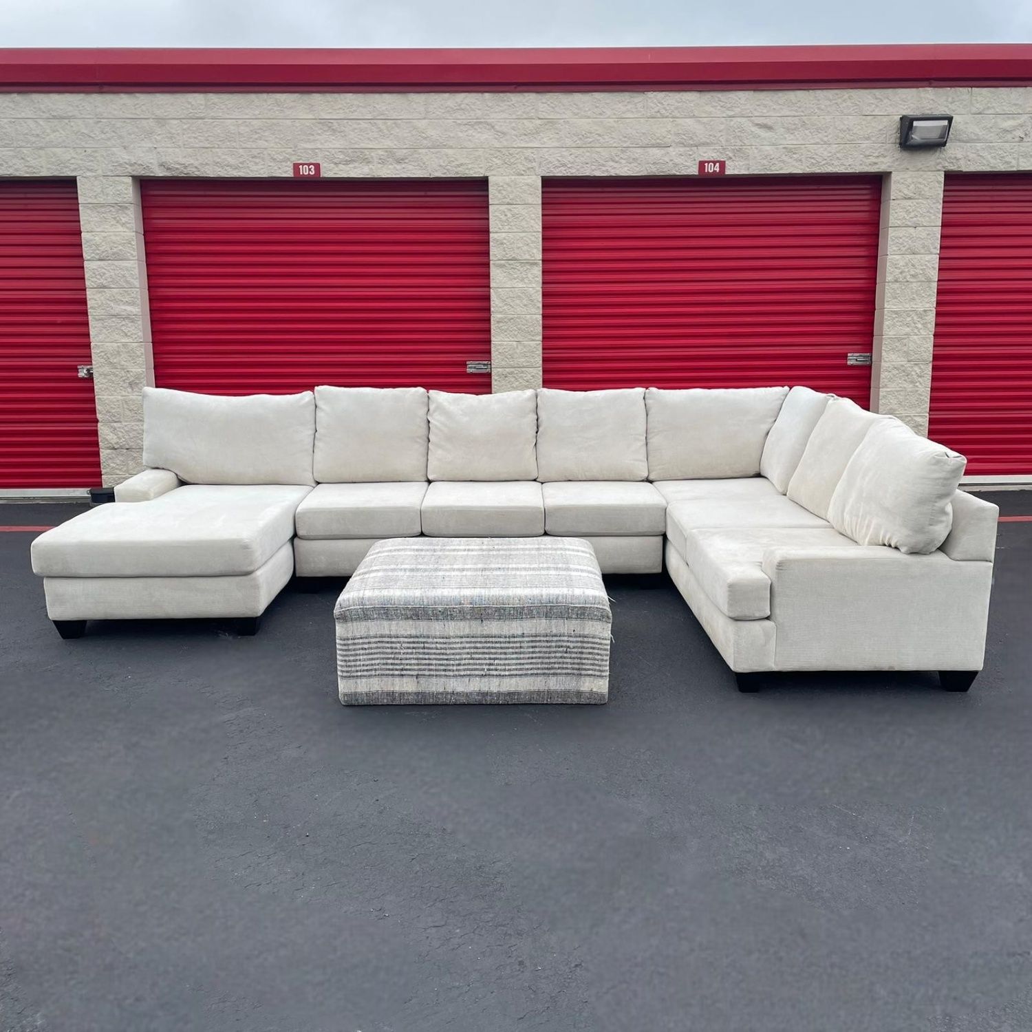 Living Spaces Sectional Couch with Striped Ottoman
