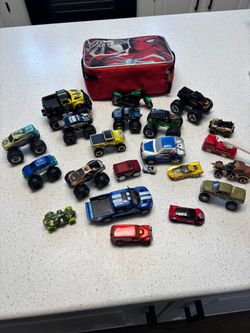 Spider-Man lunchbox full of monster trucks and other cars