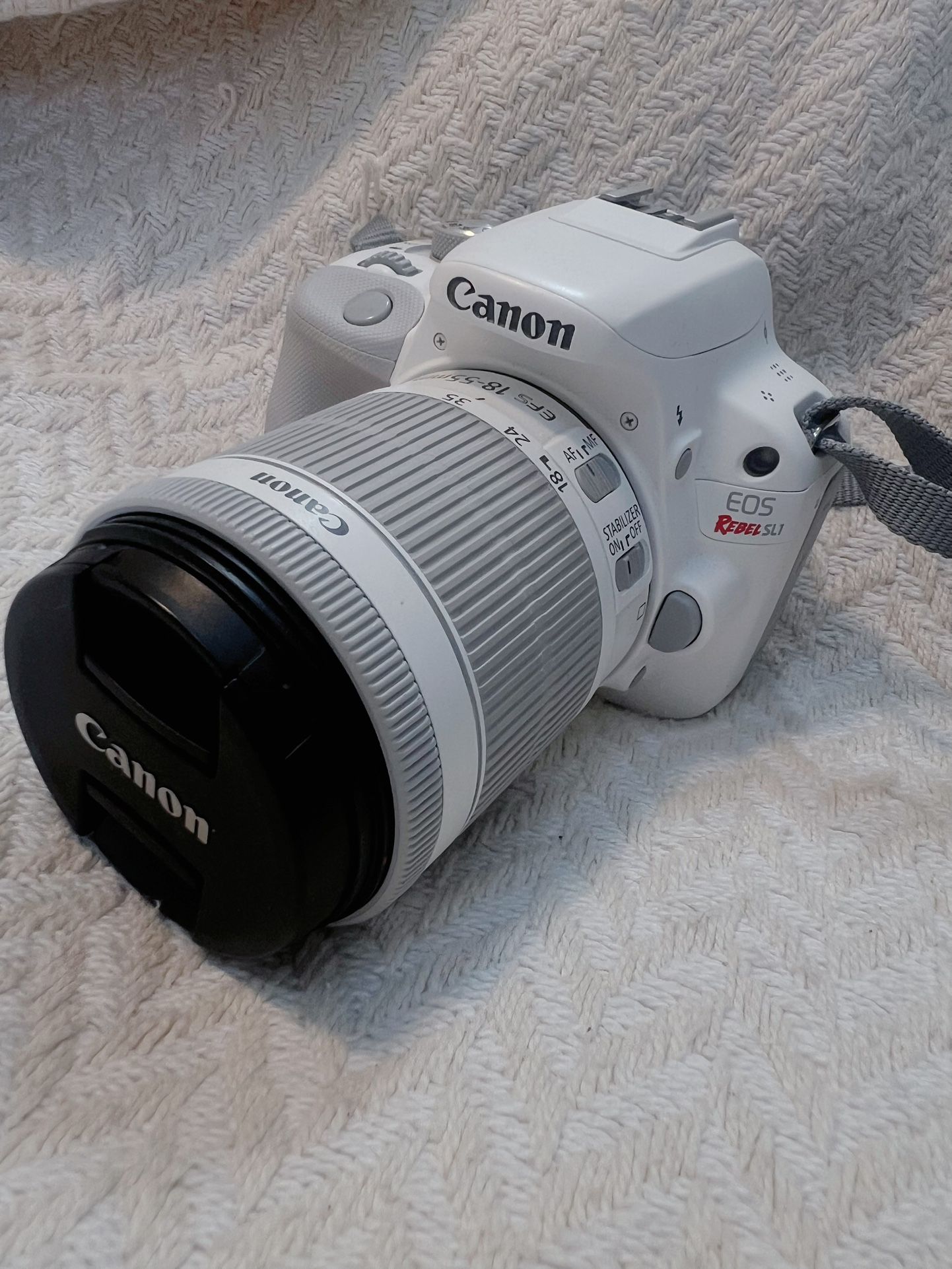 Canon EOS Rebel SL1 / 100D White DSLR Camera + 18-55mm IS STM Lens + 2 Batteries, Charger & Strap