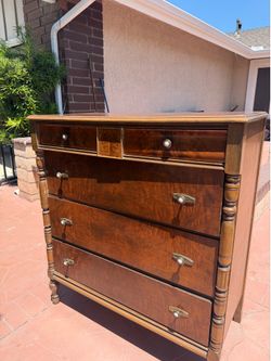 Antique American Empire style chest features a distinct book-matched flame