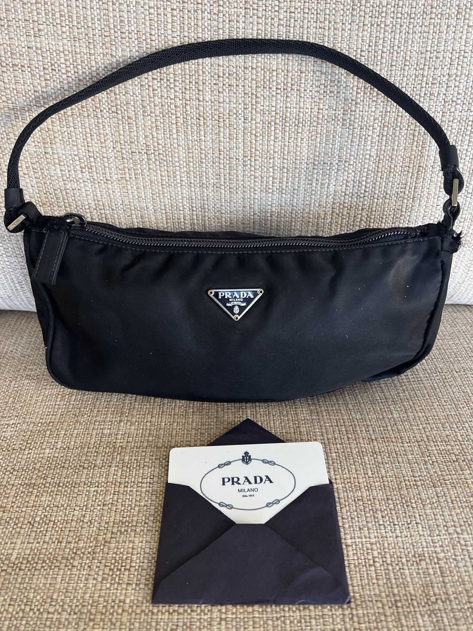 Prada Shoulder bag in canvas . It is a small bag in black