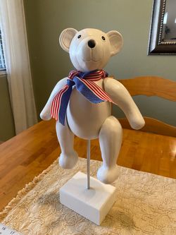 Wood jointed 13 x 9 inch teddy bear on stand.  Hairline mark on face as reflected in price.